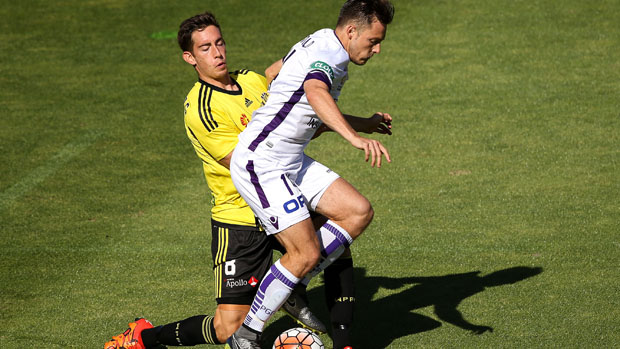 Glory striker Chris Harold holds off Phoenix midfielder Alex Rodriguez.