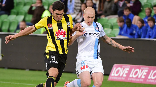 Phoenix defender Michael Boxall fights for the ball with City midfielder Aaron Mooy.
